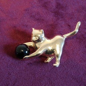 Vintage gold tone cat playing with ball